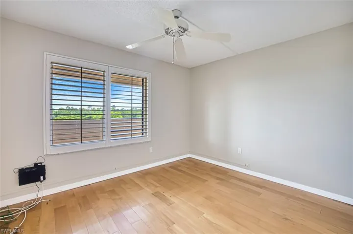2nd Bedroom room with light wood-style flooring, a ceiling fan, and a textured ceiling