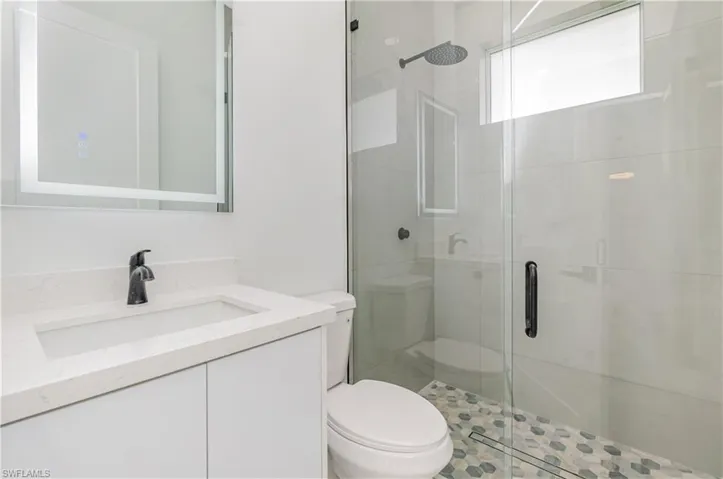 Bathroom with vanity and a shower stall