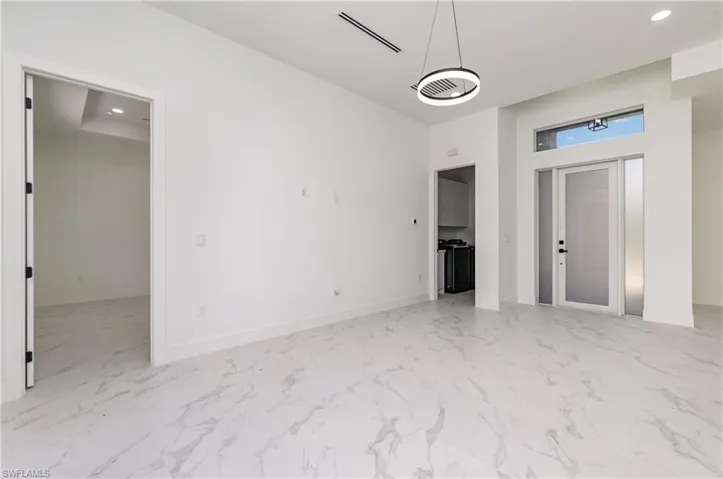 Unfurnished bedroom with recessed lighting and light marble finish floors