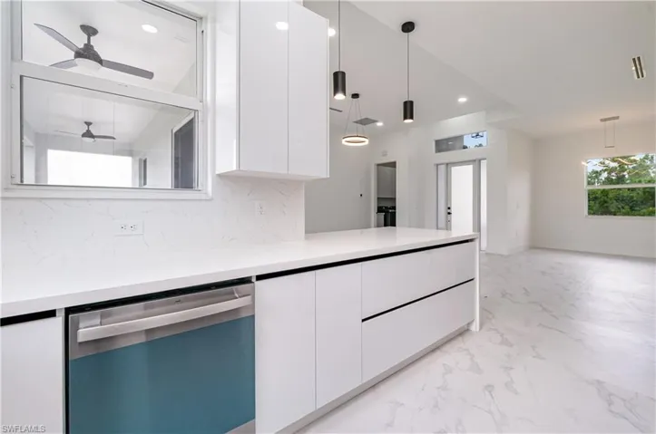 Kitchen featuring modern cabinets, white cabinetry, dishwasher, and recessed lighting