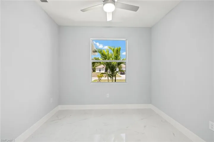 Empty room with baseboards and light marble finish floors