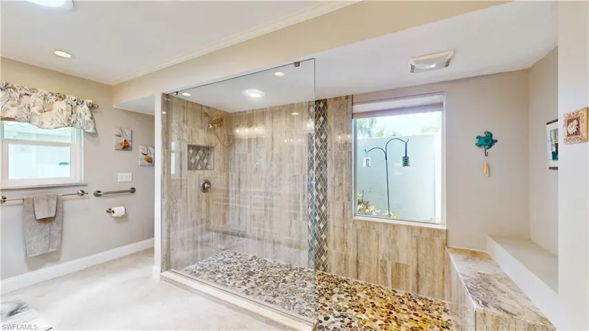 Huge walk in Shower, multi shower heads. Window with privacy wall/atrium.