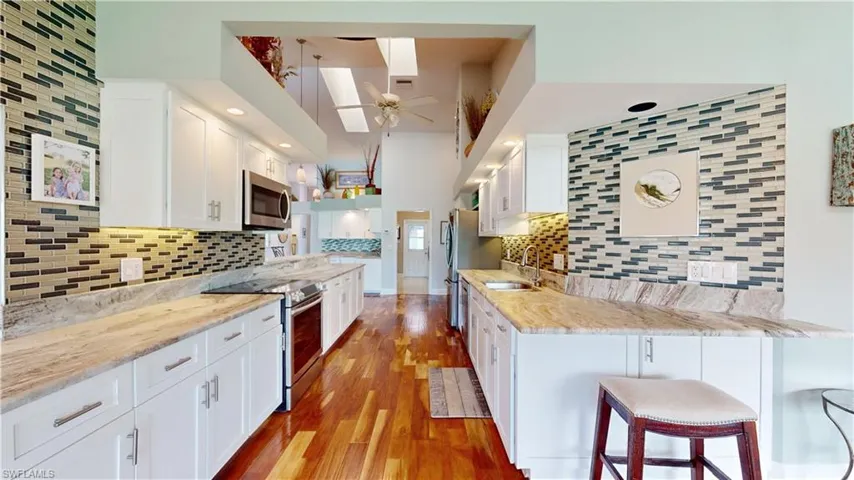 Tiled back splash, two sky lights, quartzite leathered countertops.