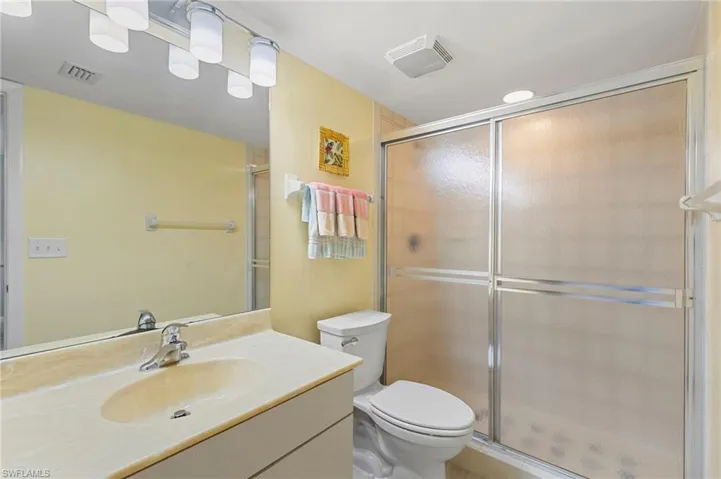 Full bathroom with vanity and a stall shower