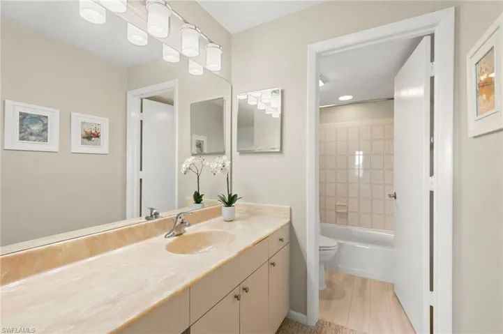 Bathroom featuring tub / shower combination and vanity