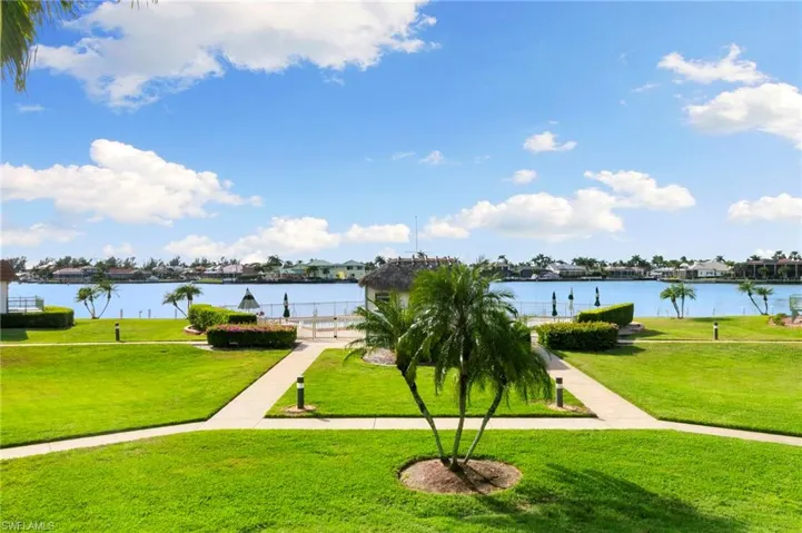 Surrounding community featuring a yard and a water view