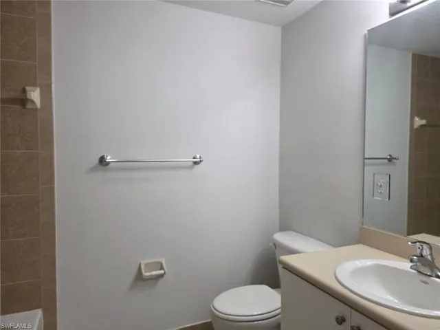 Bathroom with vanity and tiled shower / bath combo