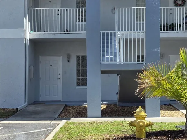 Doorway to property with stucco siding