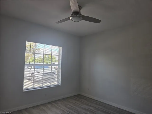 Spare room featuring light wood-style floors and a ceiling fan