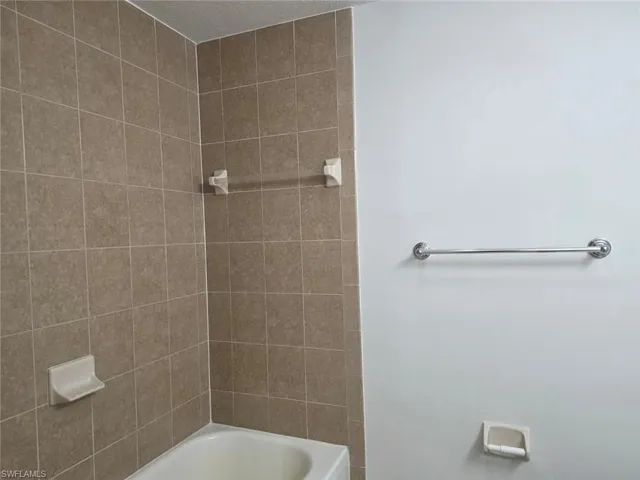 Full bath featuring bathing tub / shower combination