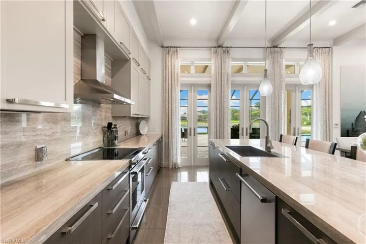 Expansive kitchen view highlighting the island, lighting, and open-concept design.