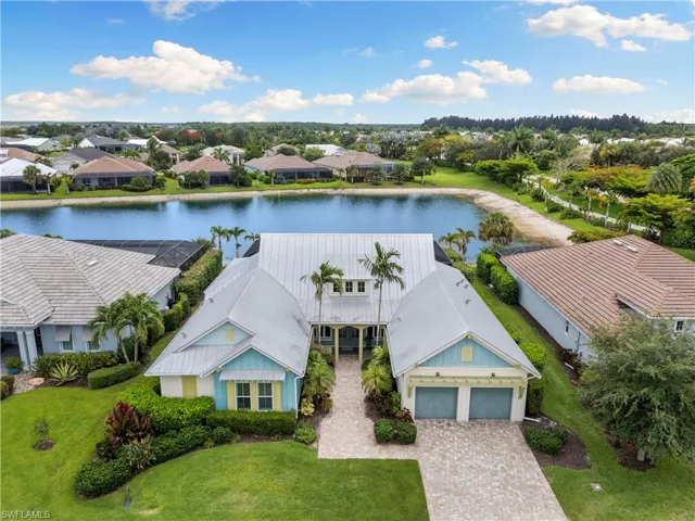 Aerial view showcasing the home's lakefront setting and spacious homesite.
