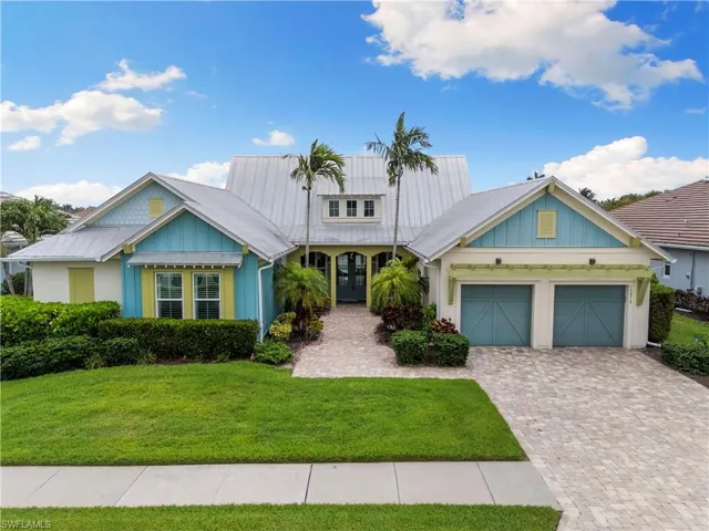 Beautiful front Key West elevation with tropical landscaping.