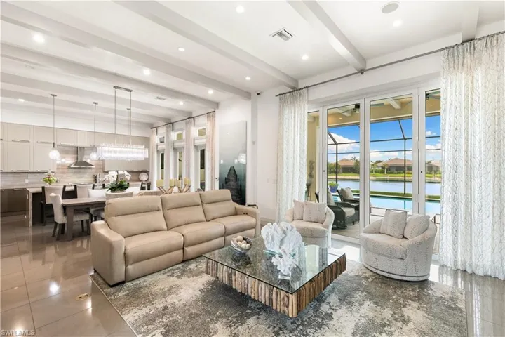 Bright open great room with tray ceiling, designer finishes, and natural light.