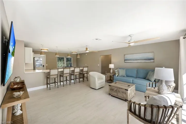 Living room and kitchen are open to one another.