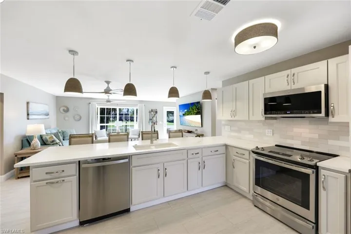 You will LOVE this beautiful kitchen featuring stainless appliances, quartz countertops, and plenty of storage space.