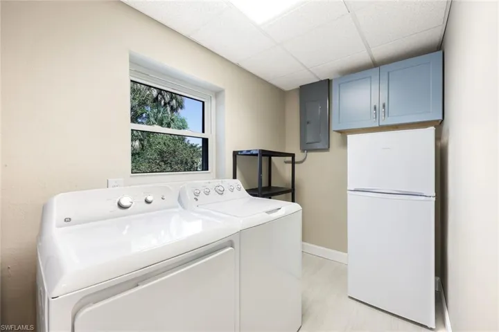 Laundry room features plenty of additional storage.