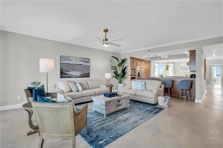 Living room featuring crown molding, plenty of natural light, and ceiling fan