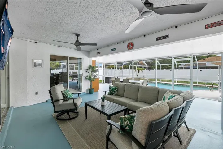 Screened lanai featuring a swimming pool, multiple ceiling fans, and a light blue finished floor