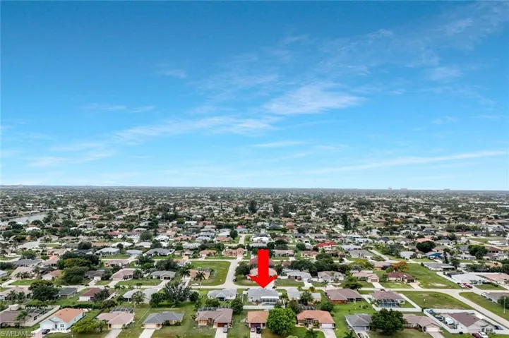 Aerial perspective showcasing a residential neighborhood with numerous single-story properties and established landscaping