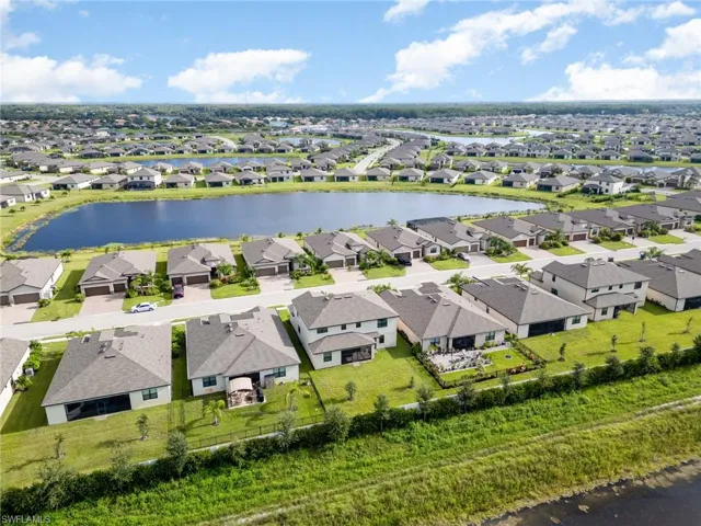 Aerial perspective of suburban area with a nearby body of water