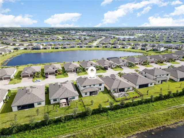 Aerial perspective of suburban area with a nearby body of water