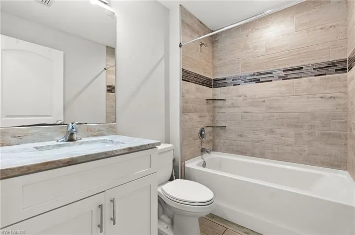 Full bath featuring bathtub / shower combination and vanity