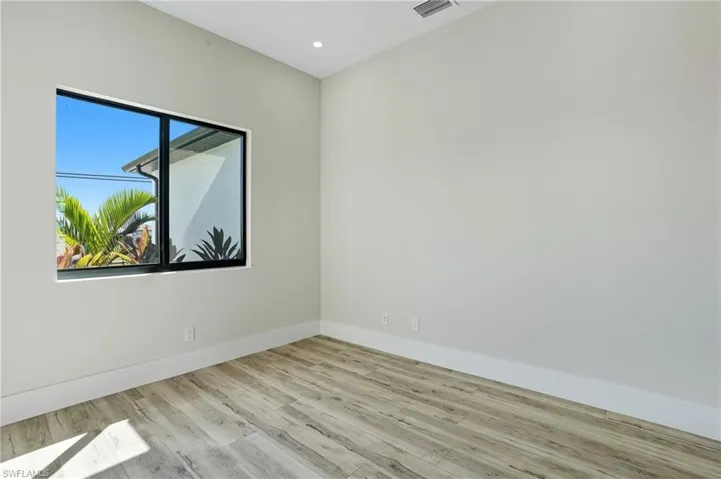 Spare room with light wood-style floors and recessed lighting