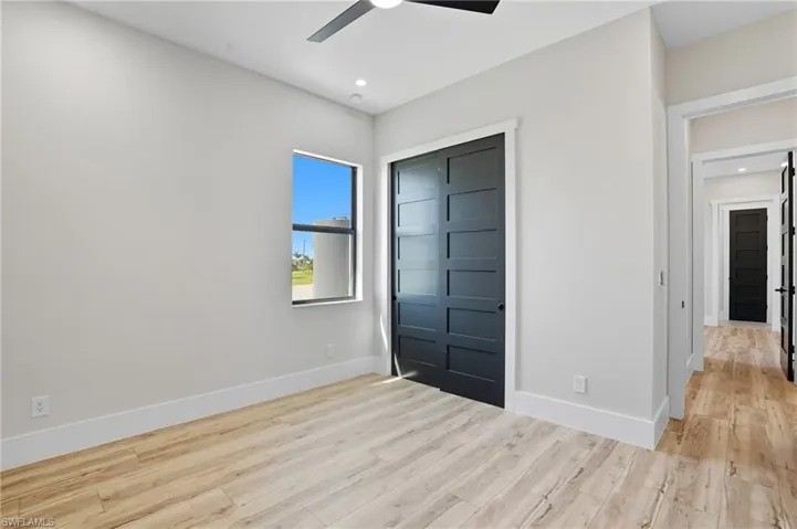 Unfurnished bedroom with a closet, light wood-type flooring, a ceiling fan, and recessed lighting