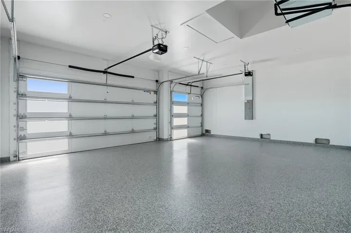 Garage with electric panel and a garage door opener