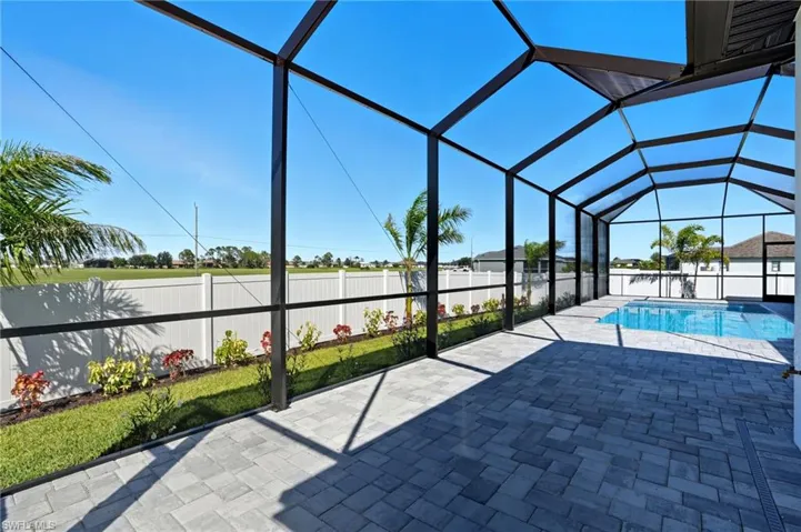 View of pool with a fenced backyard, a sunroom, glass enclosure, and a patio area