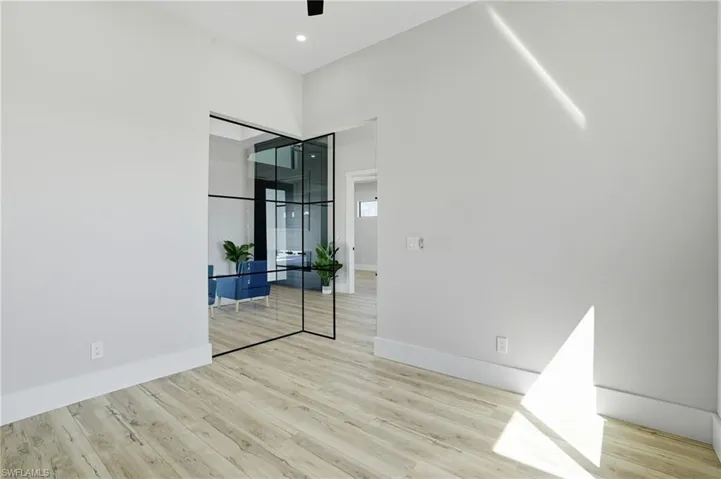 Spare room featuring light wood-type flooring and a ceiling fan