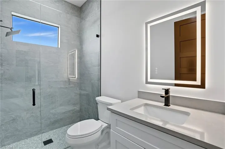 Full bath featuring vanity and a stall shower