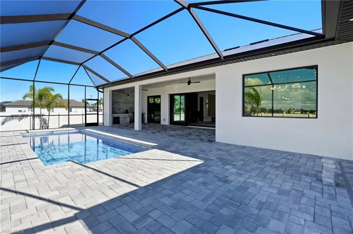Outdoor pool with a sunroom, ceiling fan, a lanai, and a patio
