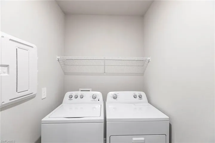 Clothes washing area featuring washer and dryer