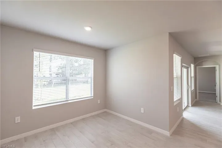 Unfurnished room featuring plenty of natural light and light hardwood / wood-style flooring