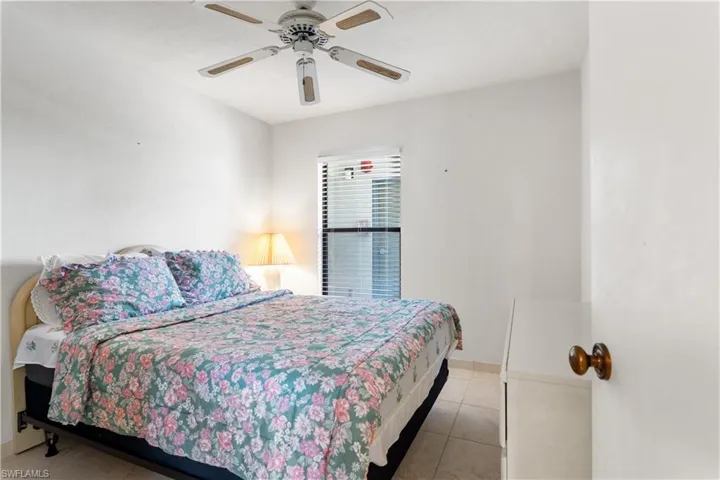 Tiled bedroom with ceiling fan
