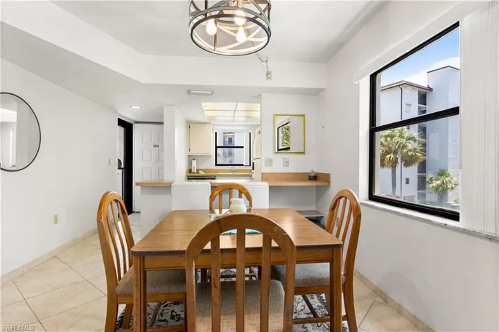 Dining room featuring light tile floors and a chandelier