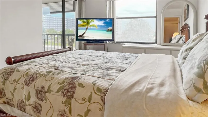 Bedroom featuring multiple windows and access to outside