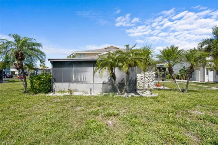 5848 Queen Elizabeth Way Unit #1 - One story, only one shared wall. Pool is just outside door.Large, screened lanai with all-season windows and nicely tiled.