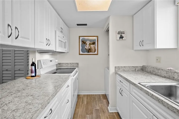 Kitchen. Nice window over the sink for lots of natural light. Updated cabinetry and countertops. Range/oven, washer/dryer, refrigerator with water/ice on the door. All kitchen items are included.