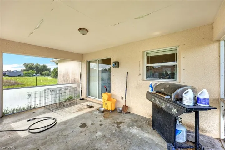View of patio with a grill
