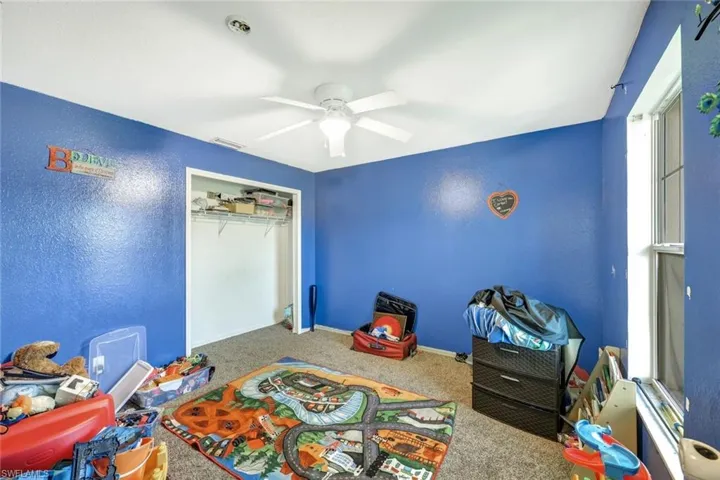Playroom featuring ceiling fan and carpet floors