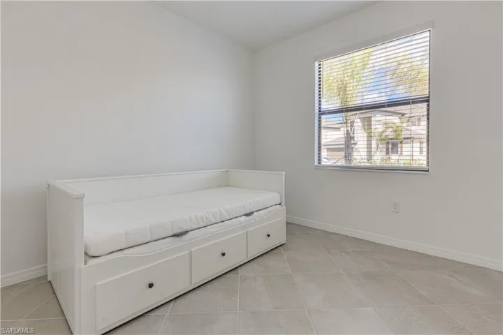 Living area with baseboards and light tile patterned floors