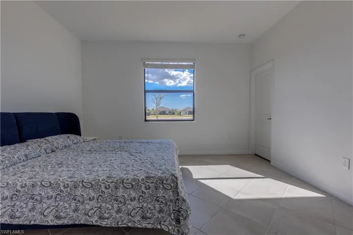 Bedroom featuring baseboards and light tile patterned floors