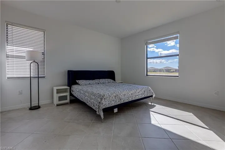 Bedroom featuring baseboards and light tile patterned floors