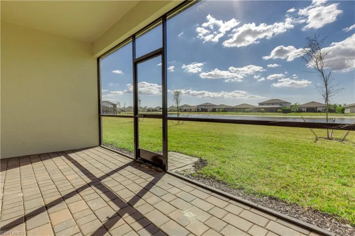 Unfurnished sunroom with a residential view and a water view