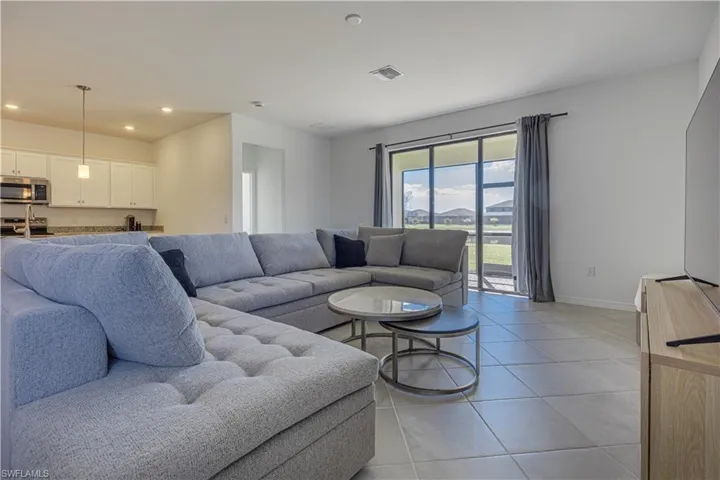 Living room featuring light tile patterned floors and recessed lighting