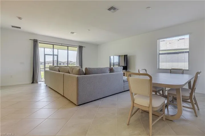 Living room with plenty of natural light and light tile patterned floors