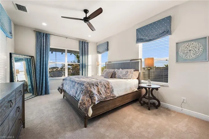 Bedroom featuring light carpet and ceiling fan